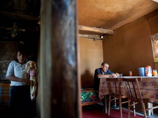 12-year-old Ani with her father on the other side of the dilapidated wall in the family’s tiny home a two-room tin and wood shack. The lack of heat when temperatures dip below freezing, caused Ani to suffer a serious respiratory illness. She began coughing up blood and the illness soon spread to her heart. Her parents tried to find a doctor who would perform the surgery Ani needed, but were turned away repeatedly because they could not pay for the surgery. At one hospital, Ani was put under anesthesia in preparation for surgery, but when the doctor found out the family could not pay, she was sent home in a semi-conscious state. A non-profit organization intervened and arranged for Ani’s surgery. She is doing much better now. Geghard village, Armenia, 2009.
