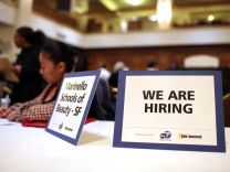 The unemployment rate for Los Angeles County jumped to nearly 10 percent in July. But employment analysts said Friday that's an improvement over 2012. (File photo: A "we are hiring" sign is displayed on a table during a job fair in San Francisco).