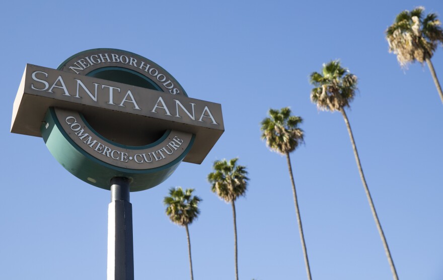 A welcome sign for Santa Ana, with palm trees in the background