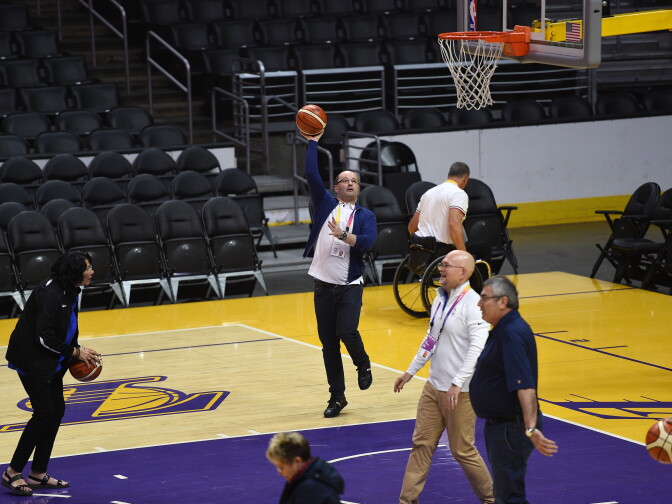 IOC Evaluation Commission Chairman Patrick Baumann shoots basket as he and commission members are given a tour of Staples Center, a proposed LA2024 Olympic venue, by Los Angeles Mayor Eric Garcetti and LA 2024 Chairman Casey Wasserman and rest of the bidding committee May 11, 2017, in Los Angeles.