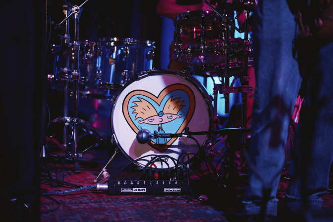 The cartoon character Arnold from Hey Arnold! is on a kick drum 