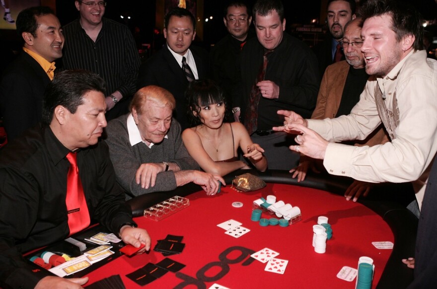 Dr. Jerry Buss, actress Bai Ling and television personality Rossi Morreale play poker at the Los Angeles Lakers 3rd annual Mirage Las Vegas Casino Night and Bodog Celebrity Poker Invitational benefiting Los Angeles Lakers Youth Foundation at Barker Hangar on April 12, 2006 in Santa Monica.