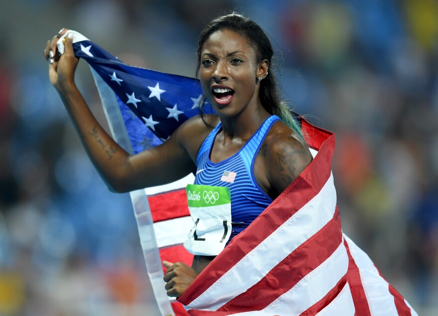 RIO DE JANEIRO, BRAZIL - AUGUST 17:  Nia Ali of the United States celebrates with the American flag after winning the silver medal in the Women's 100m Hurdles Final on Day 12 of the Rio 2016 Olympic Games at the Olympic Stadium on August 17, 2016 in Rio de Janeiro, Brazil.  (Photo by Matthias Hangst/Getty Images)