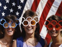 Local sports fans wear patriotic Olympic Rings sunglasses during the 1984 Olympic Games in Los Angeles.