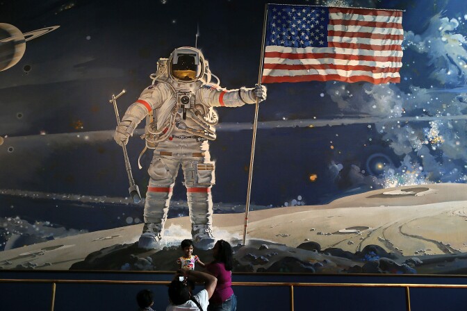 WASHINGTON, DC - AUGUST 31:  Visitors take photographs August 31, 2012 at the Smithsonian National Air and Space Museum in Washington, DC. Neil Armstrong, the first person to walk on the Moon, has died on August 25 at the age of 82. His life was celebrated at a private service today in Cincinnati, Ohio. A national memorial has been scheduled on September 12 in Washington.  (Photo by Alex Wong/Getty Images)