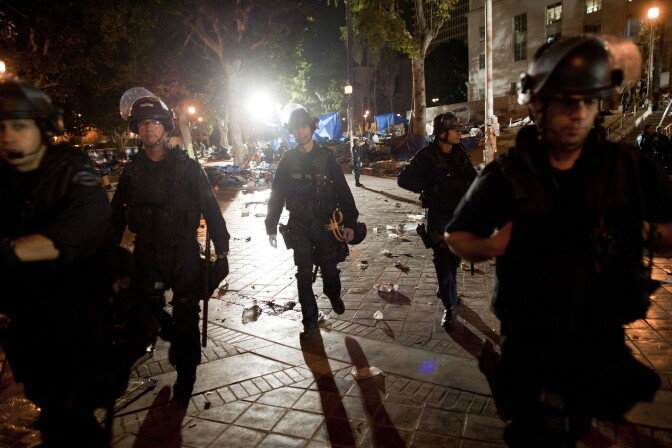 Members of the Los Angeles Police Department patrol the park in front of City Hall in downtown in the early hours of November 30, 2011 in Los Angeles, California. Protesters remained on the City Hall lawn despite a deadline, set by Los Angeles Mayor Antonio Villaraigosa, to dismantle their campsite and leave the park which the city declared closed as of 12:01 am November 28th.