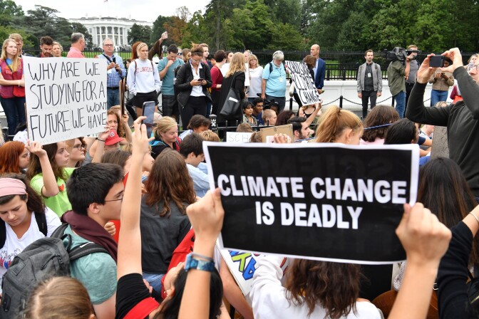 Teenagers and students take part in a climate protest outside the White House (background) in Washington on September 13, 2019. - Swedish environment activist Greta Thunberg, 16, has spurred teenagers and students around the world to strike from school every Friday under the rallying cry "Fridays for future" to call on adults to act now to save the planet. (Photo by Nicholas Kamm / AFP)        (Photo credit should read NICHOLAS KAMM/AFP/Getty Images)