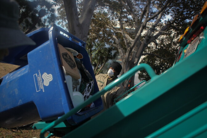 Sanitation workers clean up the site of the Occupy Los Angeles camp following protesters being removed, Nov. 30, 2011.
