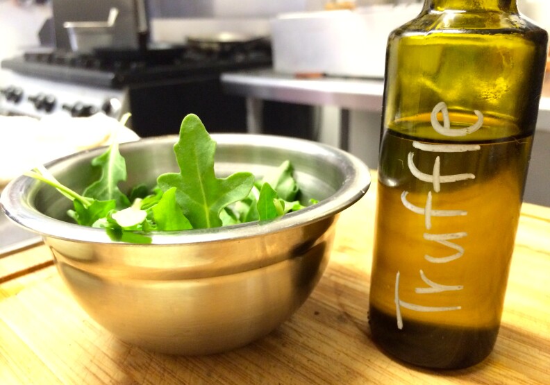Truffle oil from California to dress the arugula that's on the truffle burger.