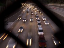 FILE - In this Nov. 22, 2011 file photo, cars travel on a freeway in San Diego. During the long 2014 holiday weekend, 46.3 million Americans are expected to go 50 miles or more from home, the highest number since 2007, according to travel agency and car lobbying group AAA. That would be a 4.2 percent increase over last year. (AP Photo/Gregory Bull, File)