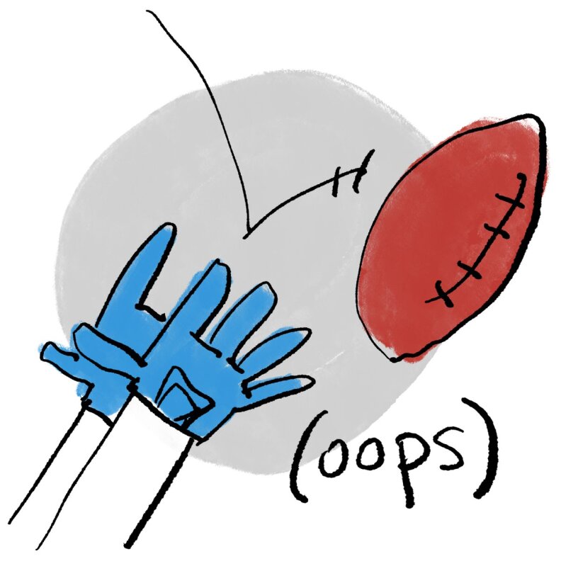 A football bounces out of the hands of a blue-gloved player (oops)