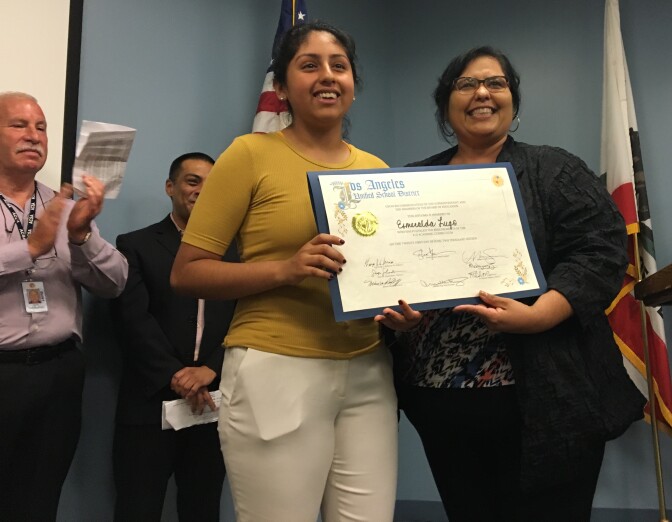 Los Angeles Unified School Board member Mónica García congratulates recent graduate Esmerelda Lugo during a ceremony at the district's headquarters on Tuesday, June 21, 2016.