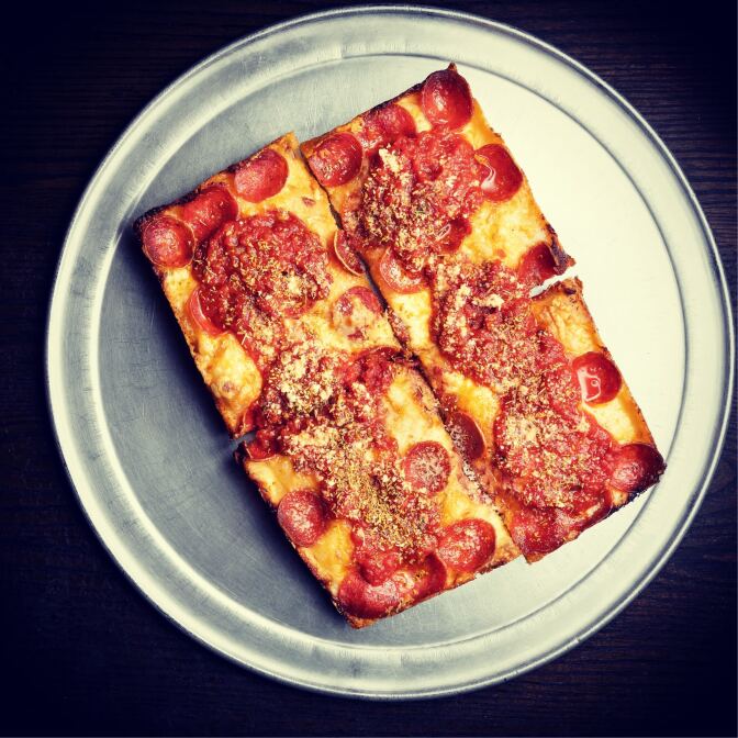4 slices of pizza sit on top of a plate.