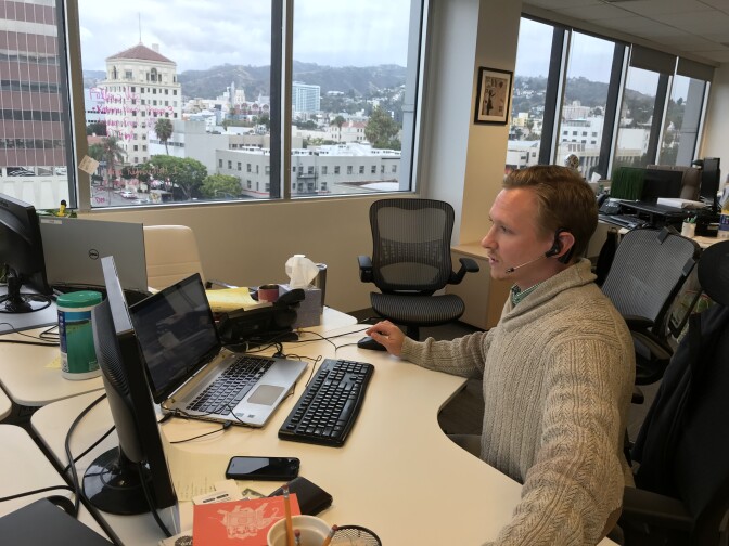 Recruiter Matt Stone calls job-seekers from his desk at the Hollywood office of Proven Recruiting, May 1, 2018. 
