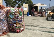 Customers sort bottles and cans at a recycling center in Eagle Rock, Aug. 8, 2019. (David Wagner/KPCC) 