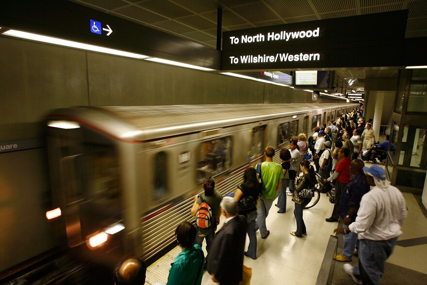 An environmental group that blocked a $237 million commuter rail project in Southern California has agreed to drop its lawsuit. The group opposed a plan to build a Riverside-to-Perris extension of the Metrolink regional train system. (File photo: Passengers board Metro subway trains during rush hour on June 3, 2008 in Los Angeles.)
