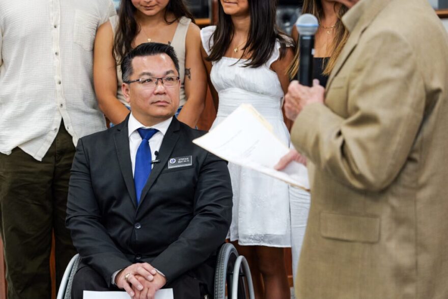 A man in suit sitting in a wheelchair 