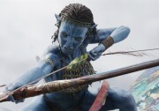 An blue Avatar character has cornrow braids and is wielding a bow and arrow, poised to shoot. \