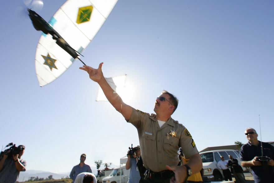 Deputy Troy Sella from the new technology department of the Los Angeles Sheriff's Department (LASD) launches the SkySeer Unmanned Arial Vehicle (UAV) drone, 16 June 2006 at a demonstration flight in Redlands, California. The LASD plans to purchase SkySeer drones to carry out surveillance and rescue operations. It will be the first time UAVs, long used by the military in war zones, will be used by law enforcement.