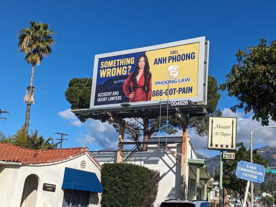 A billboard in blue and yellow advertising for a personal injury lawyer named Anh Phoong.