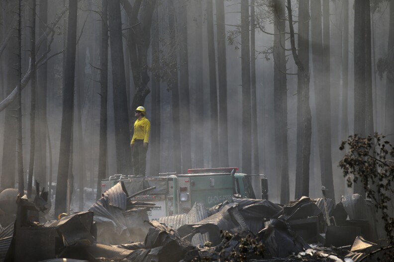 A firefighter stands on top of a fire truck at a campground destroyed by the Rim Fire near Yosemite National Park, Calif., on Monday, Aug. 26, 2013. Crews working to contain one of California's largest-ever wildfires gained some ground Monday against the flames threatening San Francisco's water supply, several towns near Yosemite National Park and historic giant sequoias. (AP Photo/Jae C. Hong)