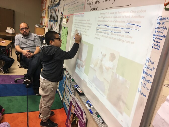 Michael Ramirez, a first-grade teacher at 20th Street Elementary School just south of downtown L.A., teaches a lesson in his bungalow classroom on Dec. 6, 2017. (Photo by Kyle Stokes/KPCC)