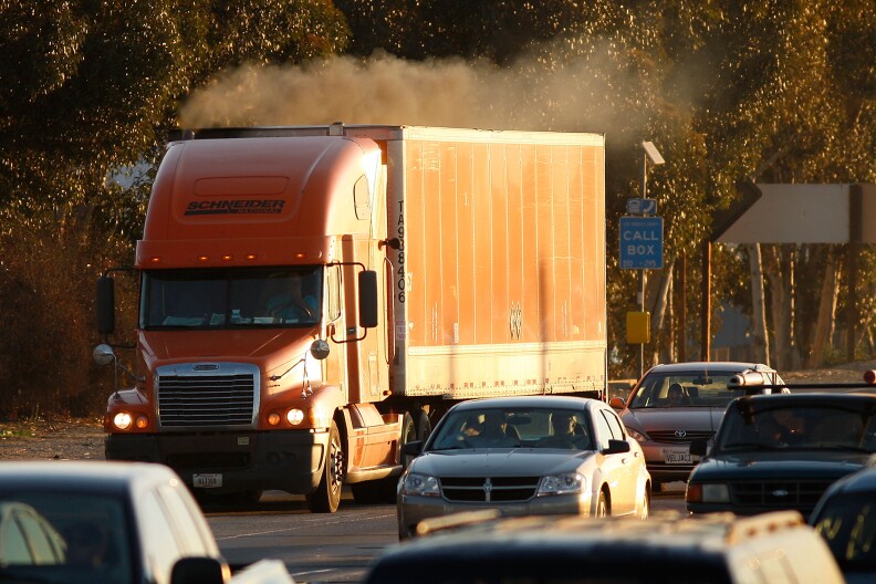 Diesel smoke spews from a truck as morning commuters travel the 210 freeway near Pasadena in Los Angeles County. A federal judge has dismissed a trucking association's lawsuit against new rules intended to reduce truck and bus pollution in California. (Photo by David McNew/Getty Images)
