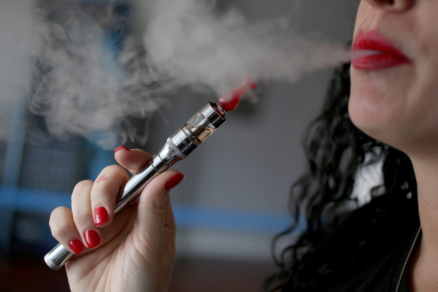 MIAMI, FL - FEBRUARY 20:  Julia Boyle enjoys an electronic cigarette at the Vapor Shark store on February 20, 2014 in Miami, Florida. As the popularity of E- cigarettes continue to grow, leading U.S. tobacco companies such as Altria Group Inc. the maker of Marlboro cigarettes are annoucing plans to launch their own e-cigarettes as they start to pose a small but growing competitive threat to traditional smokes.  (Photo by Joe Raedle/Getty Images)