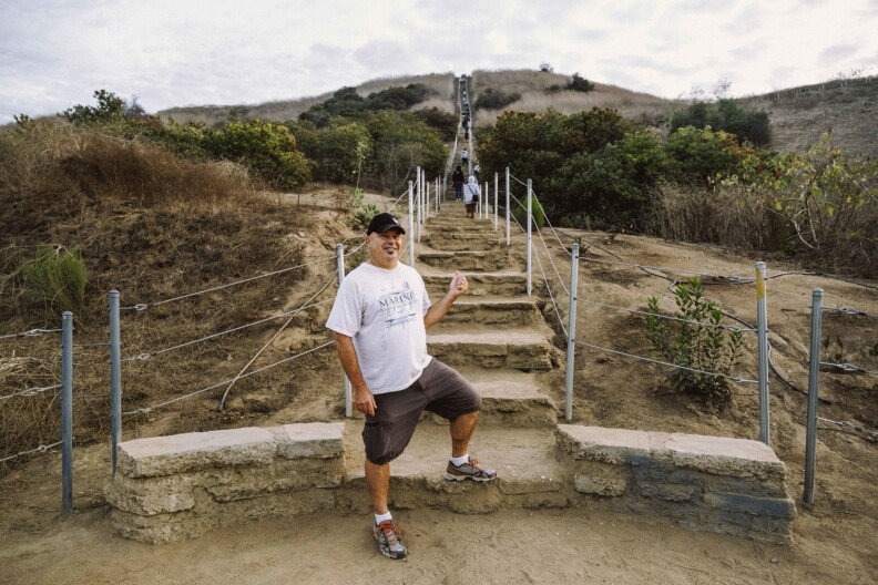 Evyn Charles starts his third climb up the stairs to the Baldwin Hills Scenic Overlook. He says he's trying to lose his quarantine weight.
