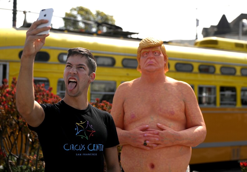 AUGUST 18:  A man takes his picture with a statue depicting Republican presidential nominee Donald Trump in the nude in San Francisco. Anarchist collective INDECLINE has created five statues and placed them in five U.S. cities: San Francisco, New York, Los Angeles, Cleveland and Seattle.