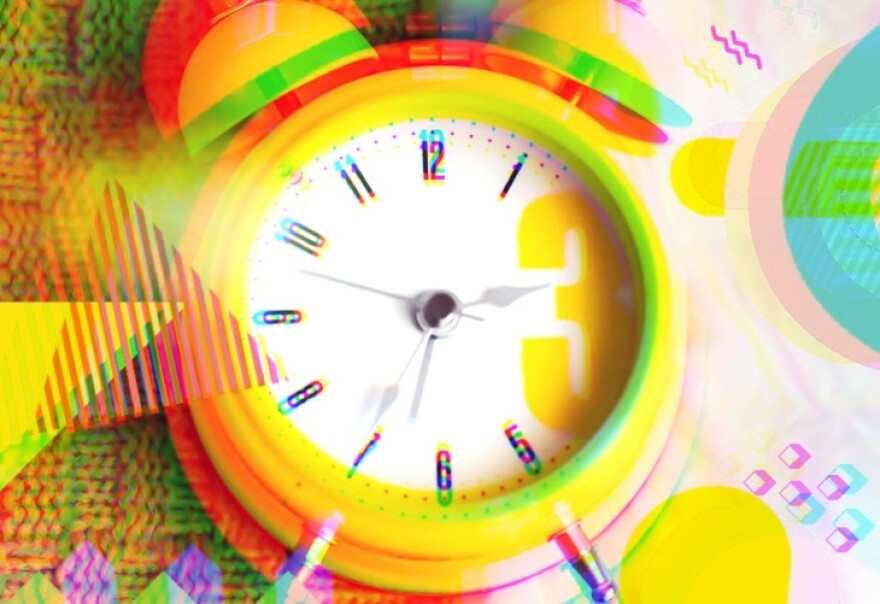A yellow alarm clock with an analogue face is shown at the center of a photo illustration. The clock has two small bells on top. Around it are illustrated shapes, such as triangles, squares and zigzags.