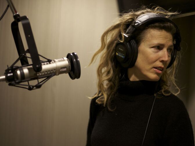 Sophie B. Hawkins looks for her cue from a KPCC engineer as she records a song live at KPCC.