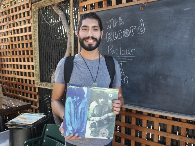 Jasson Gomringer shows off his free album by jazz saxophonist John Klemmer.
