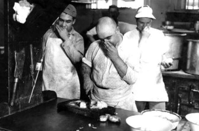 "If you have tears to shed, prepare to shed them now" says Albert Rossi as he attacks an onion at Lincoln Heights jail kitchen. Photo dated: July 20, 1929. 
