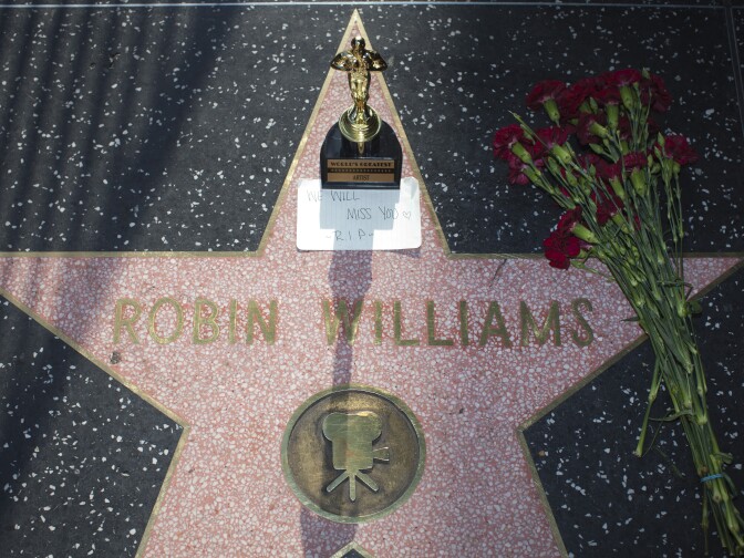 Items are left in memory of Robin Williams on his star along Hollywood Boulevard.