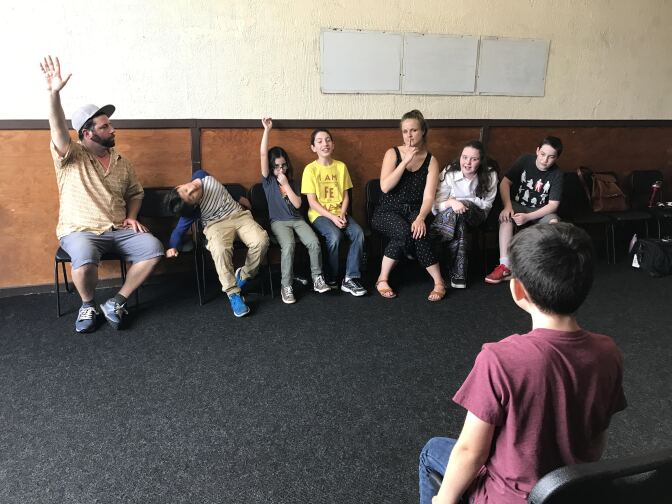 Will Todisco and Maja Miletich leading their kids in a game of "Stone Face," a game where they have make one of the kids laugh.