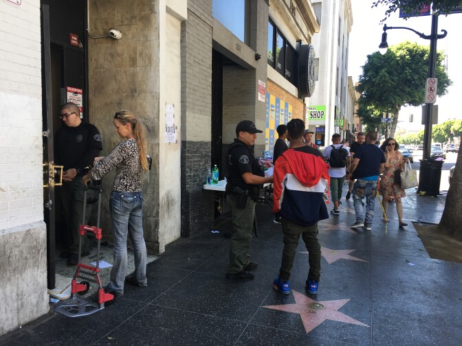 Former occupants of an illegally converted commercial building had to confer with security guards to retrieve their belongings after a police raid to vacate the building at 6362 Hollywood Blvd.
