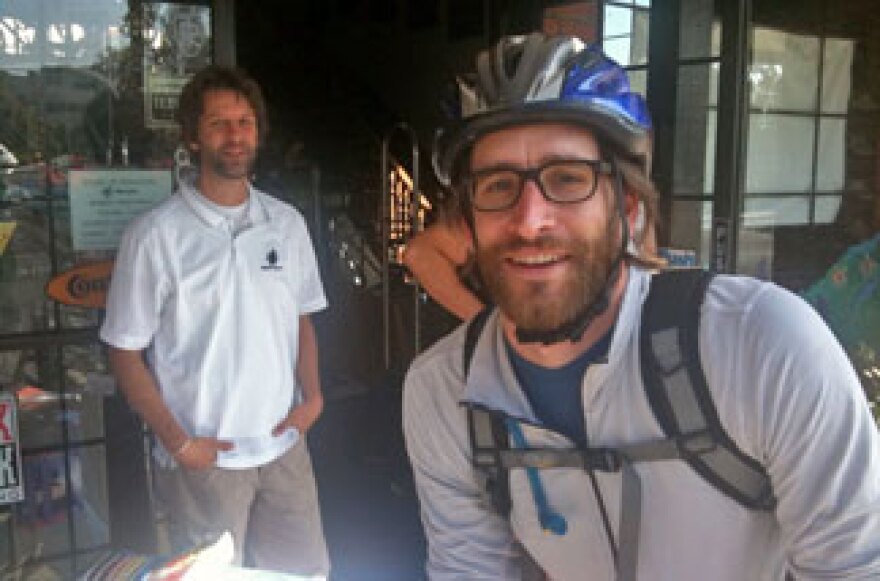 Michael Schodorf (front) makes a pit stop at Helen's Cycles in Santa Monica where Brad Edwards (back) offered energy bars, water and bike gear. Schodorf has commuted 10 miles to work for the past three years.