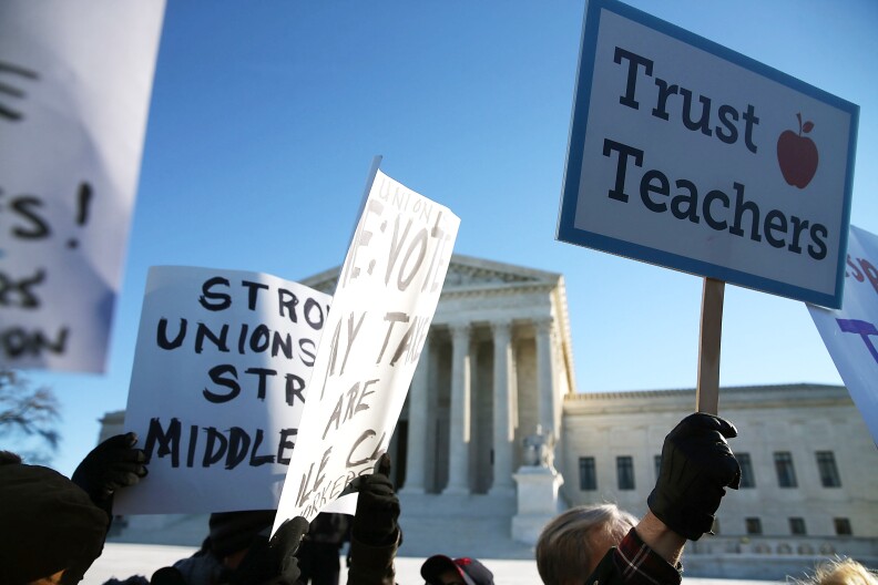 WASHINGTON, DC - JANUARY 11:  People for and against unions hold up signs in front of the US Supreme Court building January 11, 2016 in Washington, DC. The high court is hearing arguments in the Friedrichs v. California Teachers Association case.ÊThe case will decide whether California and twenty two other states can make public-employees, such as public school teacher Rebecca Friedrichs, to pay union agency fees.  (Photo by Mark Wilson/Getty Images)