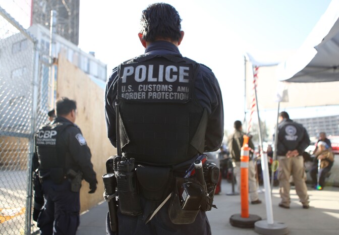 SAN YSIDRO, CA - APRIL 09:  A U.S. Customs and Border Protection officer stands guard as pedestrians enter the United States at the San Ysidro port of entry on April 9, 2018 in San Ysidro, California. President Trump has issued a decree for the National Guard to guard the 3,200 kilometer border between the United States and Mexico.  (Photo by Mario Tama/Getty Images)