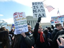 Same-sex marriage supporters demonstrate in front of the Supreme Court on March 27, 2013 in Washington, DC. The rights of married same-sex couples will come under scrutiny at the US Supreme Court on Wednesday in the second of two landmark cases being considered by the top judicial panel. After the nine justices mulled arguments on a California law that outlawed gay marriage on Tuesday, they will take up a challenge to the legality of the Defense of Marriage Act (DOMA). The 1996 law prevents couples who have tied the knot in nine states -- where same-sex marriage is legal -- from enjoying the same federal rights as heterosexual couples.