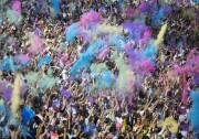 File:  People throw brightly-colored powder at the Holi Festival of Colours at Wembley Park on Aug. 13, 2016 in London, England.