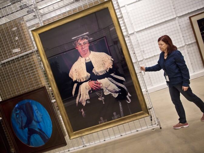 Vicki Gambol, director of collections management, pulls out a piece by Cindy Sherman from the storage space for color photography. The space is kept at 60 degrees Fahrenheit.