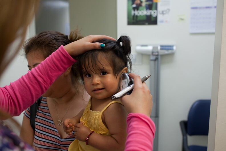 A doctor at South Central Family Health Center examines a patient on June 12th, 2012.