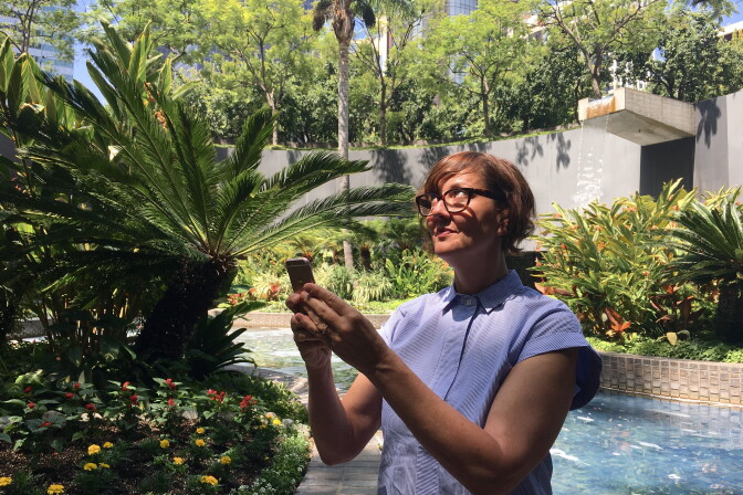 LA Department of Cultural Affairs General Manager Danielle Brazell plays "Pokemon Go" outside the Bank of America building in Downtown Los Angeles.