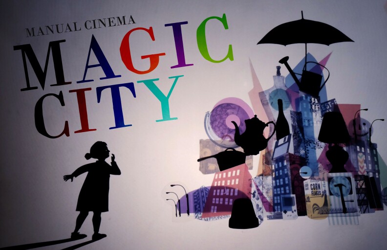 A digital banner for the stage show "The Magic City," loosely adapted from Edith Nesbit’s 1910 novel. It a young girl see in silhouette as she gazes at a colorful city in awe. The city made up of colorful building and black objects stacked on top of each other.