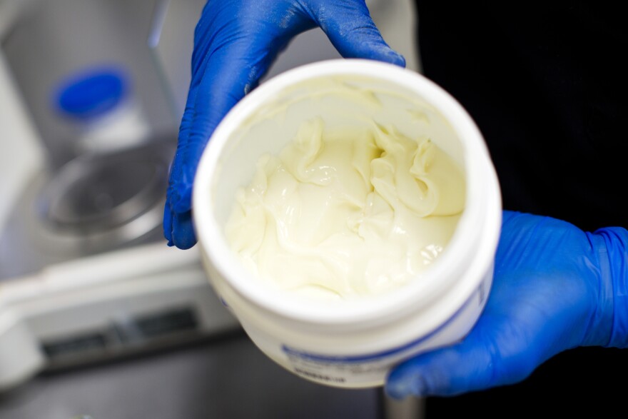 A transdermal cream base is added to the solvent and powder mixture. The transdermal cream base is made to ensure the medication in a compound cream is fully absorbed through the skin.