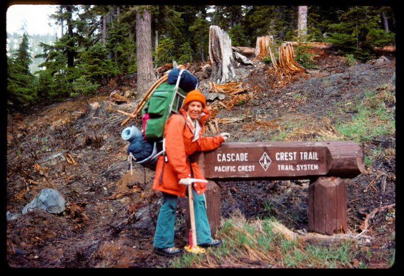 Teddi Boston poses with a Pacific Crest Trail sign in 1976. Boston was able to take a few self-portraits during her solo hike using her camera's auto-timer. 