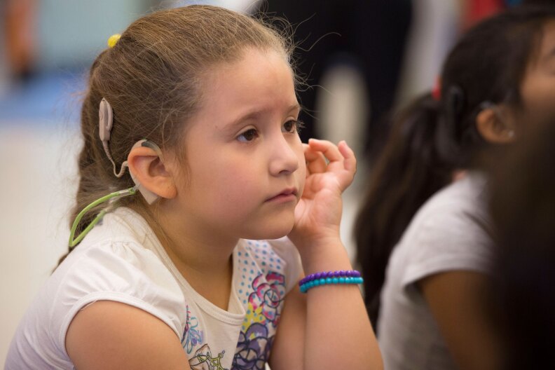 Yurianna Lara, 6, participate in a dialogic reading exercise  during the innovative "Come Read With Me" USC Program that helps develop literacy for deaf and hard of hearing children from bilingual families, July 21, 2016. (USC Photo/Gus Ruelas)