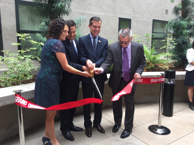 Mayor Eric Garcetti cuts the ribbon at the grand opening of the New Pershing Apartments in Downtown Los Angeles, a subsidized housing development for formerly homeless veterans on July 30, 2015.